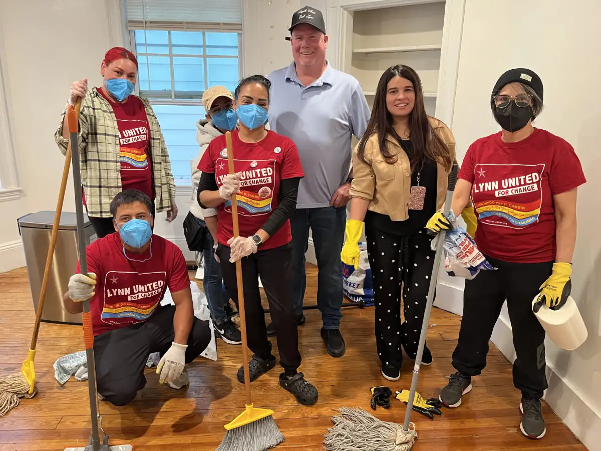 group of volunteers some holding mop or broom