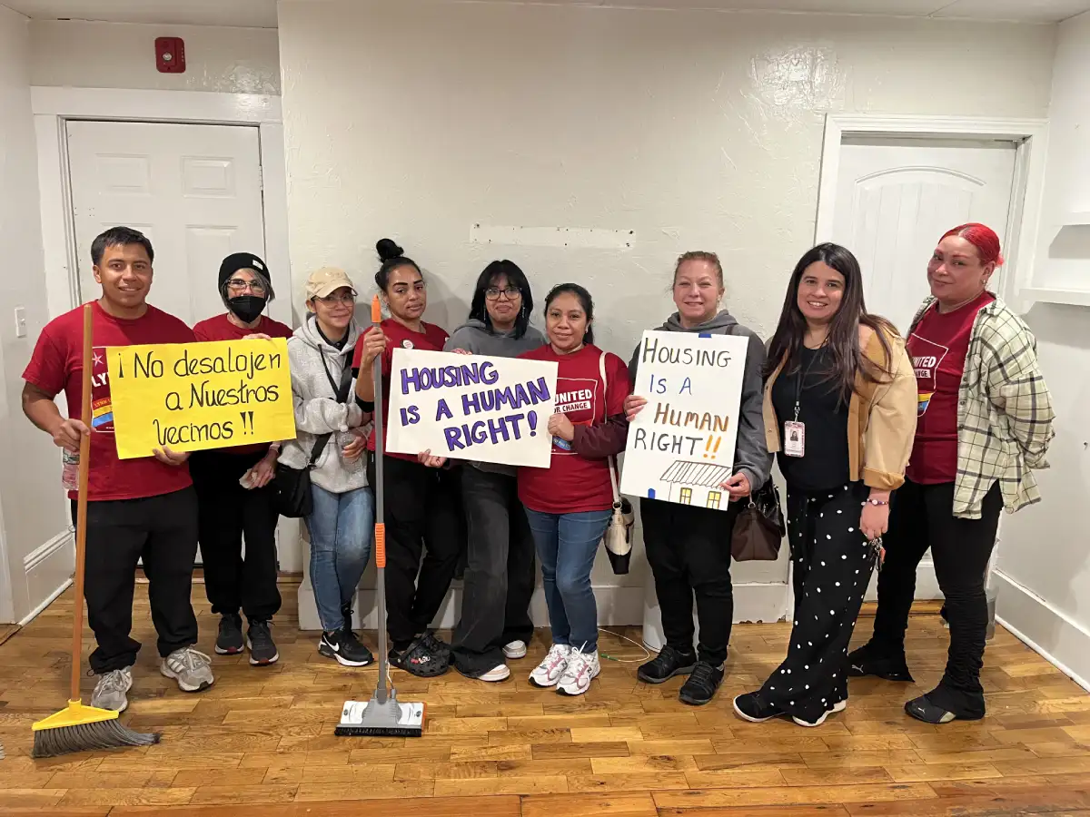 group of volunteers some holding housing justice signs